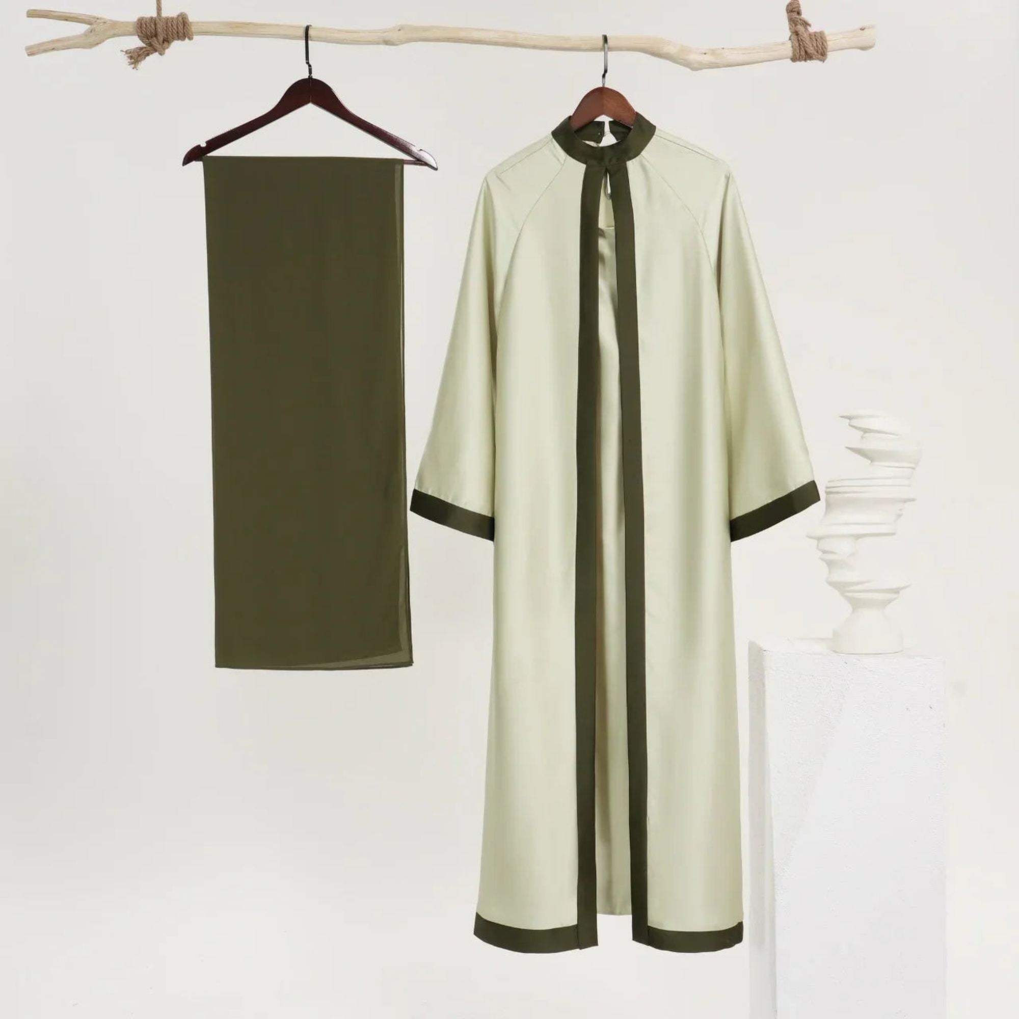 Elegant modest abaya with olive trim and matching scarf from ZAHRA'S BEST, displayed on hangers.