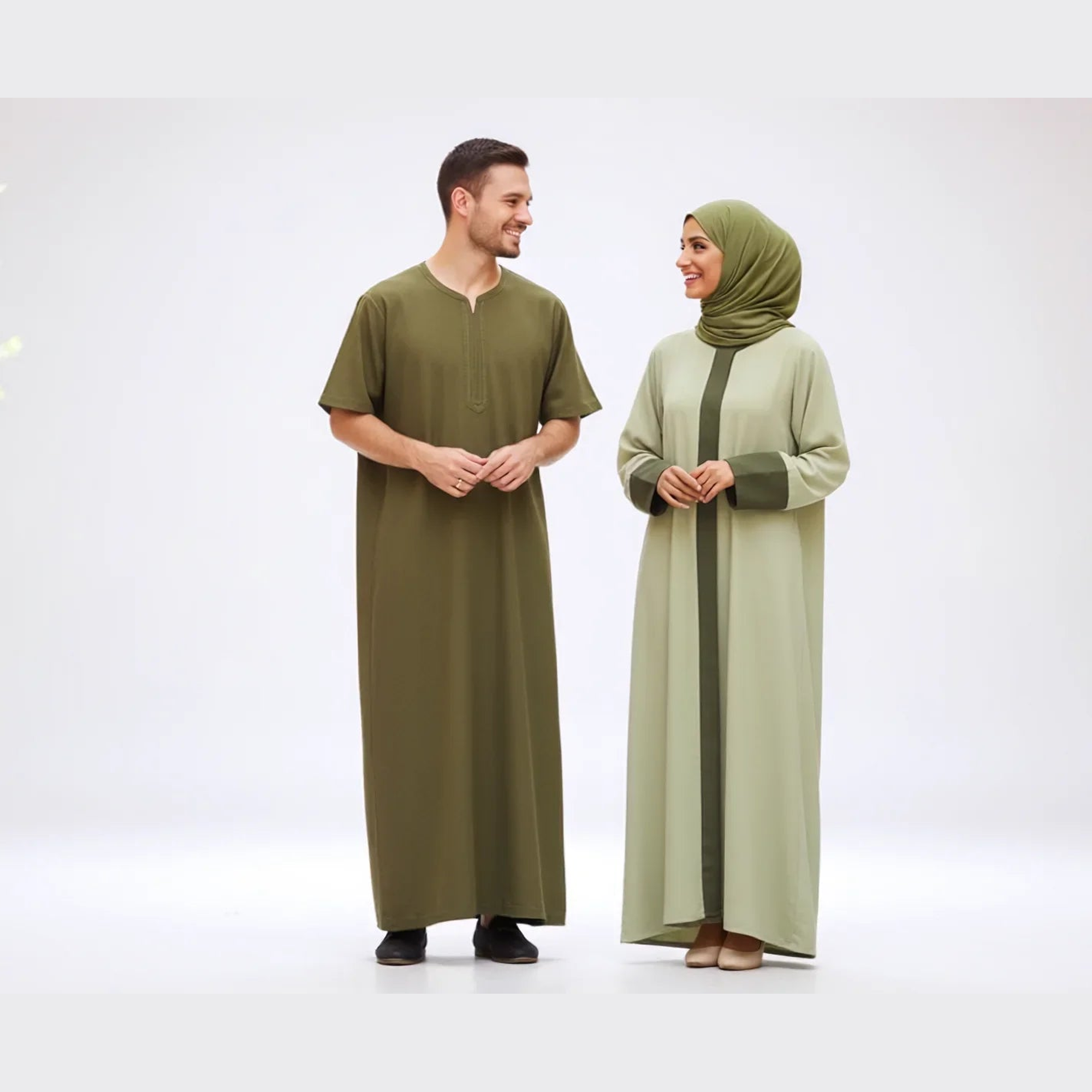Studio portrait of man in olive thobe and woman in green modest dress and hijab, Zahra's Best