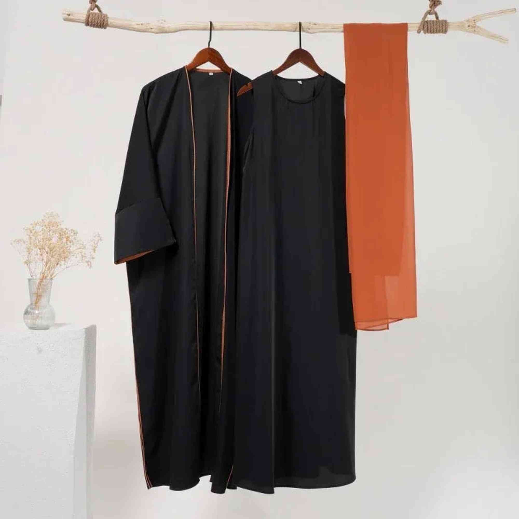 Elegant black modest wear set with rust trim and matching rust-colored hijab, Zahra's Best.