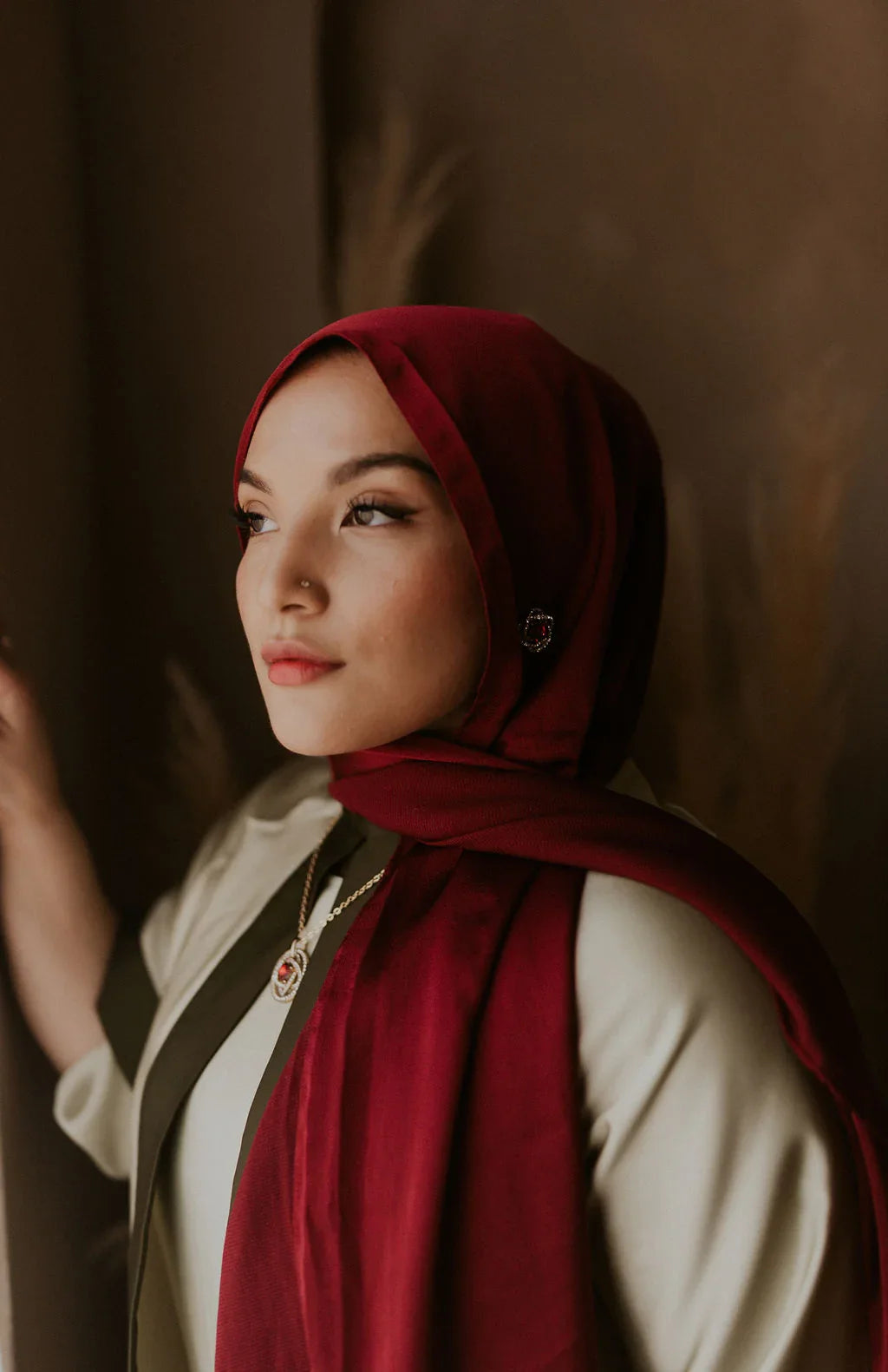 Woman in elegant maroon hijab and modest wear, styled for ZAHRA'S BEST fashion look