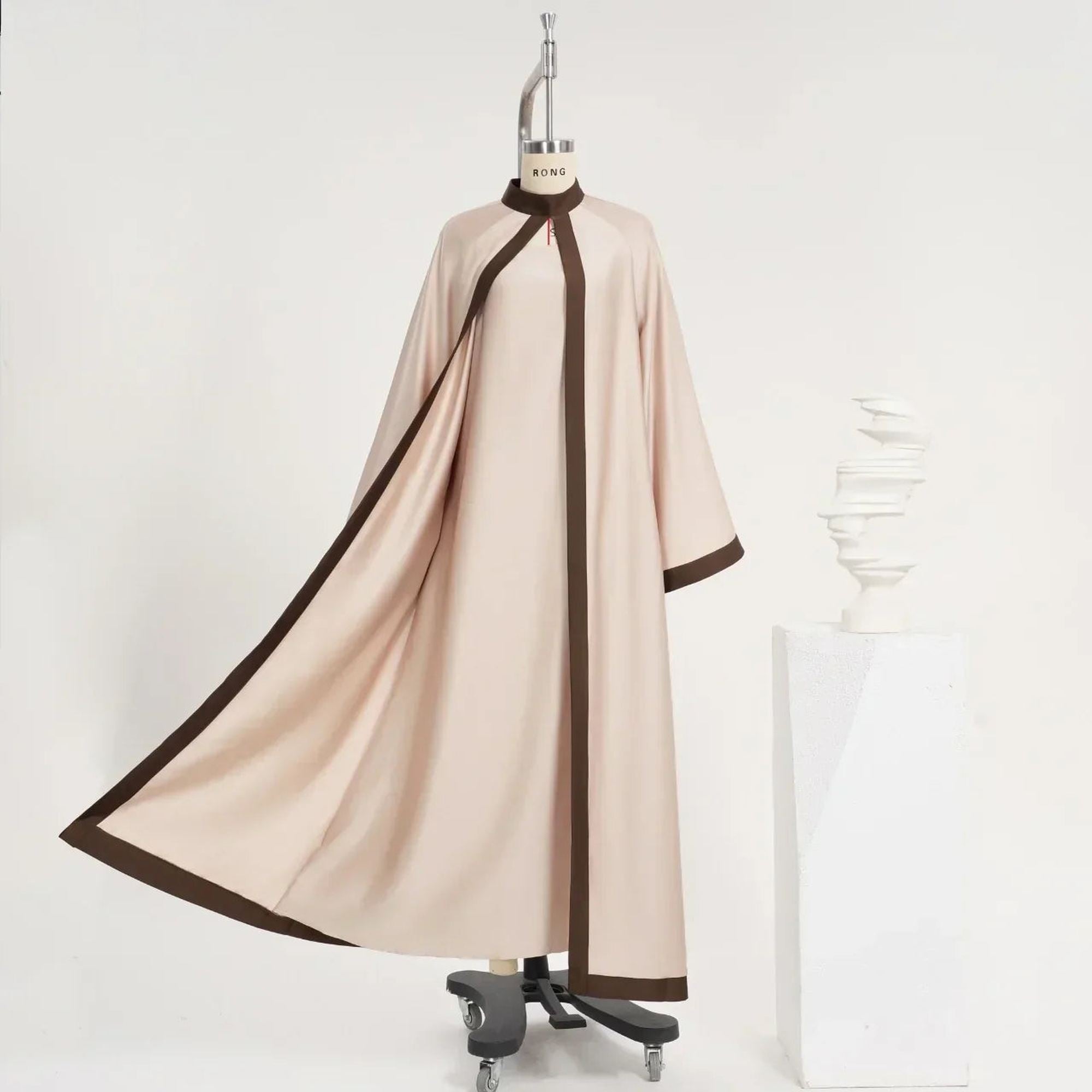 Elegant beige abaya with brown trim on mannequin, Zahra's Best modest fashion style