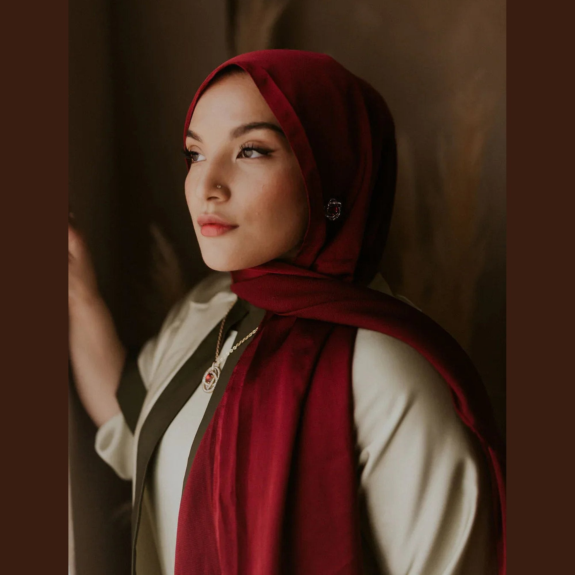 Woman in elegant maroon hijab and modest wear, styled for ZAHRA'S BEST fashion look