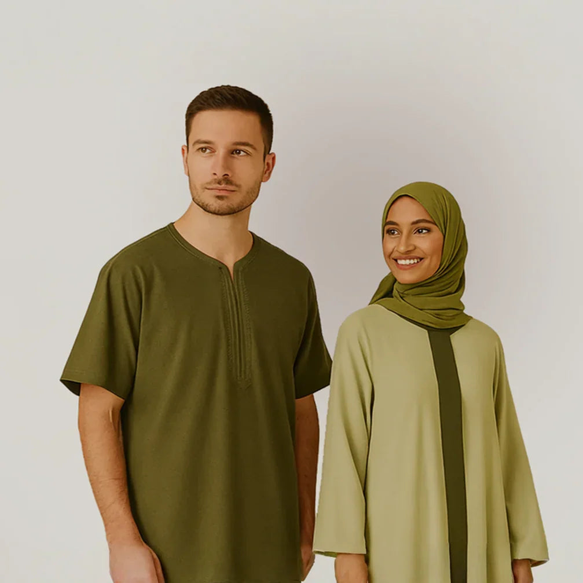 Man in olive green tunic and woman in modest light green dress and hijab, ZAHRA'S BEST